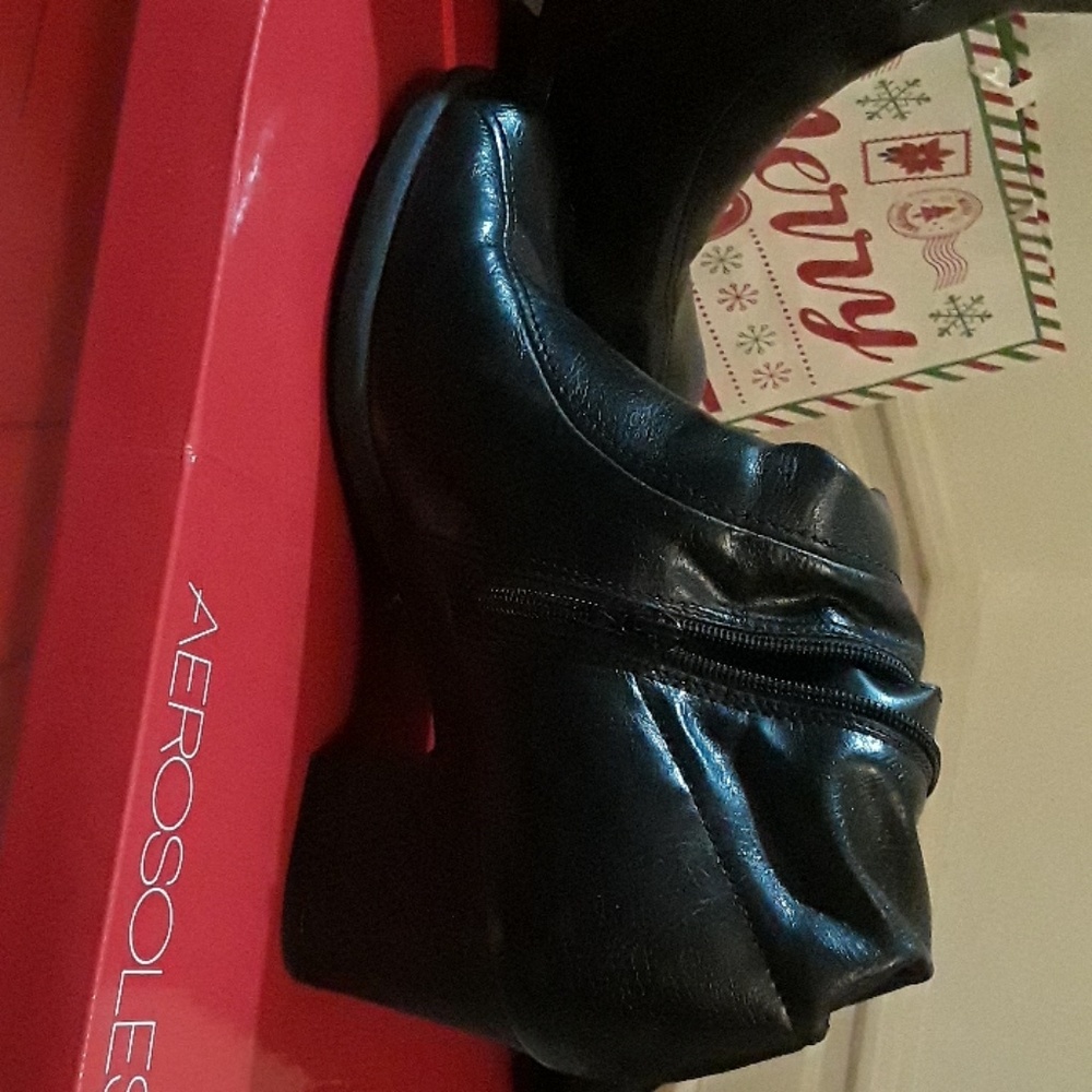 Black boots with zipper on the side.
